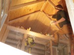 Stuffing wool between rafters in the ceiling.